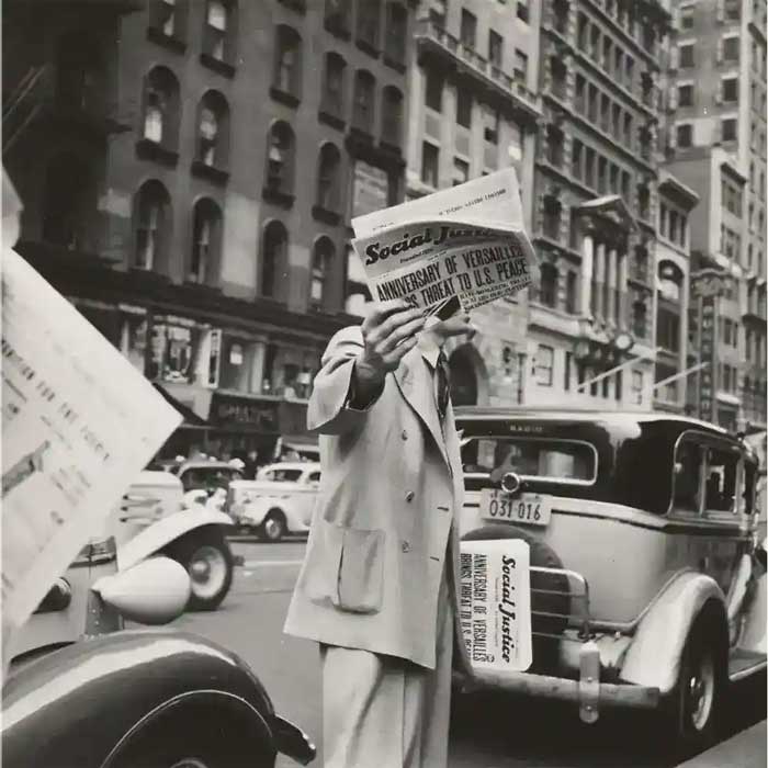 Image of man holding a newspaper in black and white for history quiz